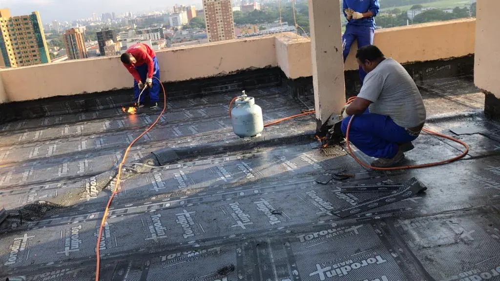 Aplicação de manta asfáltica com maçarico na laje de cobertura do Condomínio Betilana